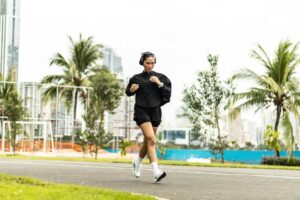 Woman jogging outdoors in an urban park, embracing active lifestyle changes to support medical weight loss, cardiovascular health, and long-term wellness.