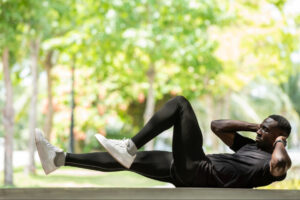 Man performing outdoor core strengthening exercises, illustrating personalized fitness strategies that support metabolic health, insulin regulation, and sustainable weight management.