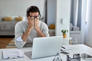 Person experiencing fatigue while reviewing information about potential side effects of Cagrilintide therapy