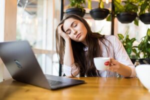 Woman experiencing fatigue while reviewing information about potential treatment side effects