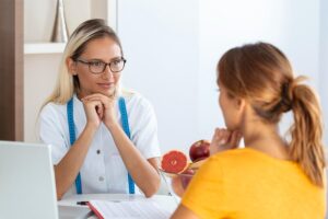 Healthcare professional evaluating a patient before starting Tesofensine weight loss therapy