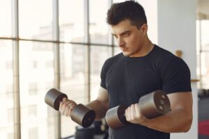 Man performing strength training exercises to support fitness goals during testosterone replacement therapy
