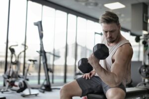 Man exercising in a fitness center while participating in a medically supervised testosterone replacement therapy program